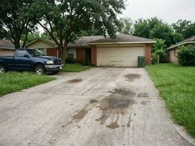 Stained concrete driveway before pressure washing